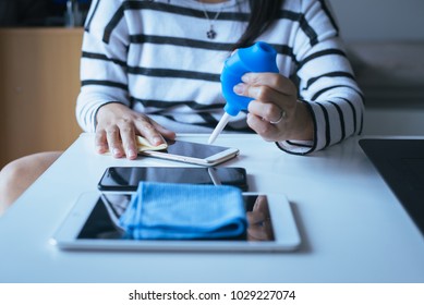 Hand Woman Cleaning Cell Phone On Screen With Microfiber Cloth,close Up