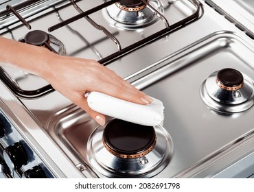 hand of woman cleaning a kitchen with a white scourer - Powered by Shutterstock