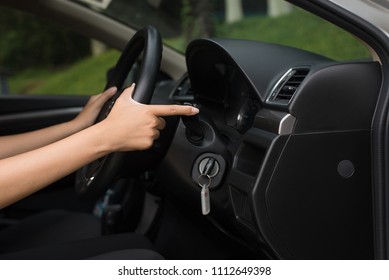 Hand woman driver using turn signal control light in car