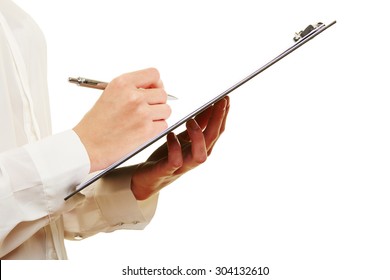 Hand Of A Woman Filling Out Checklist On A Clipboard