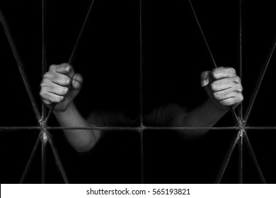 hand of woman holding cage, abuse, human trafficking concept with black shadow in white tone