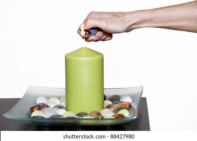 Hand Of A Woman Lighting A Large Candle With A Lighter