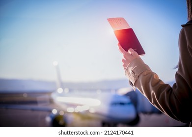 Hand Of Woman Passenger Holding Passport With Boarding Pass Worry In Delay Of The Flight In Airport Terminal Transfer Area, Flight Delay Or Misssing Flight Attention In Disaster Travel.
