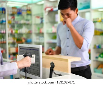 Hand Of Woman Pharmacist Holding Scanner Bar Code On Box Pr Container Of Medicine, Selling To Sick Man Customer In Background