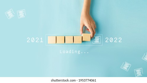 Hand Of Woman Putting Wood Cube Countdown To 2022. Loading Year 2021 To 2022.