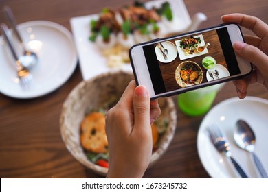 The Hand Of A Woman Take Pictures Of Food Made By Herself. Food Sellers Take Photo With A Smartphone To Post On The Online Food Ordering Website.