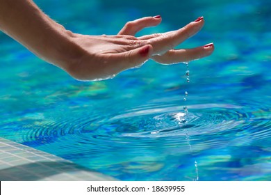 The Hand Of Woman Is Touching Water