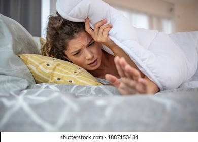 Hand Of Woman Turn Off Alarm On Call Mobile Phone While Wake Up After Sleep Relax In Good Morning At Bedroom. Woman Sleeping In Bed Being Woken By Mobile Phone