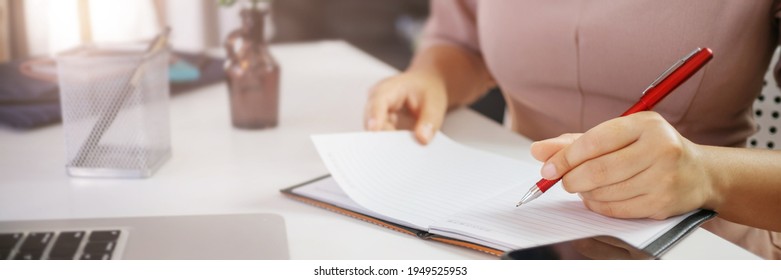 Hand Of Woman Writing Journal Entry In A Diary At Home