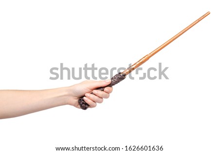 Hand with wooden magic wand, wizard and magician tool. Isolated on white background.