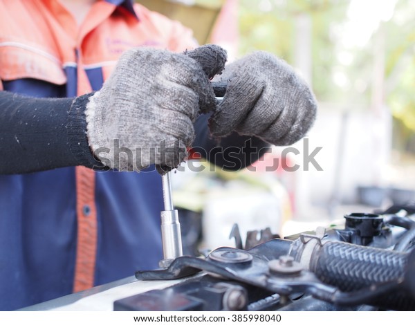 hand work repair car\
engine with tools