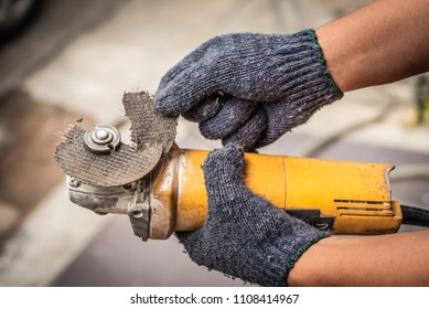 Hand Of Worker Man Hold Grinder Blades Broken . Dangers Of Using Power Tools