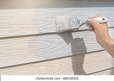 Hand Of Worker Painting On Wood Wall New House At Construction Site. 