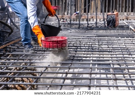 Hand of worker sprinkling chemical of Crystalline wareproofing before pour concrete slab for Structural Crystalline waterproofing system at site construction Stock foto © 
