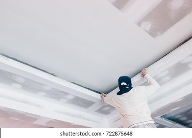 Hand Of Worker Using Gypsum Plaster Ceiling Joints At Construction Site