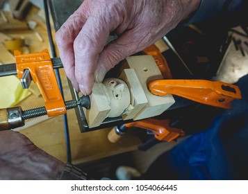 Hand Working On A Doll Head