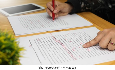 hand working on paper for proofreading - Shutterstock ID 747423196