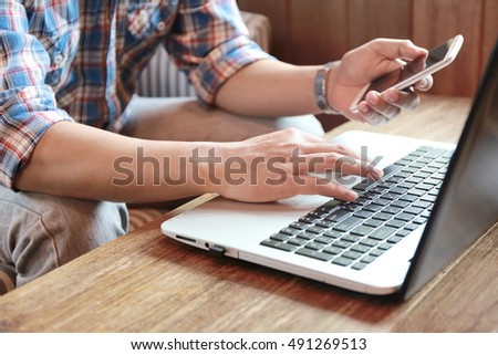 hand write note on paper with hold credit card with laptop shopping online,personal loans,businessman hand busy at office desk.