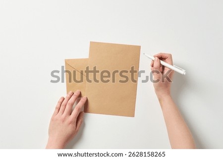 a hand to write on a paper sheet