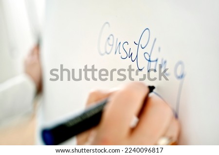 hand writes advice on blackboard