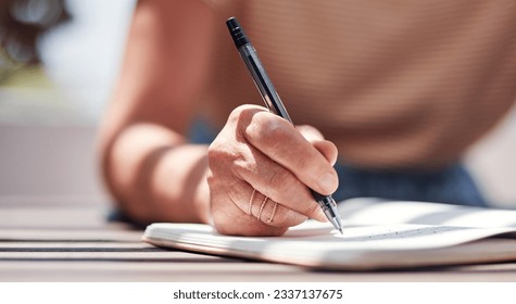 Hand, writing and book with a woman author sitting outdoor in summer for inspiration as a writer. Idea, planning and notebook with a female person using a pen to write in her journal or diary outside - Powered by Shutterstock