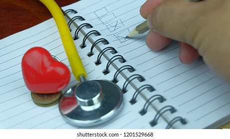 Hand writing check list for health. - Powered by Shutterstock