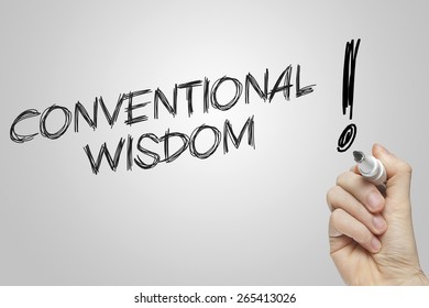 Hand Writing Conventional Wisdom On Grey Background