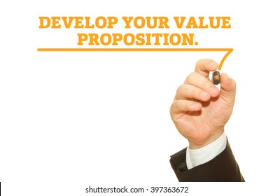 Hand writing "Develop your value proposition" on a transparent wipe board.