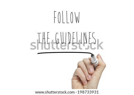 Hand writing follow the guidelines on a white board