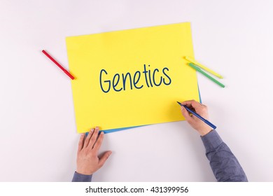 Hand writing Genetics on yellow paper