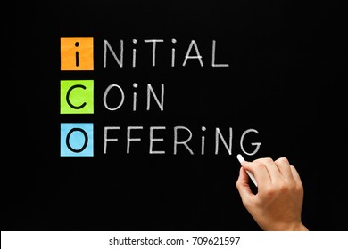 Hand Writing ICO - Initial Coin Offering With White Chalk On Blackboard.