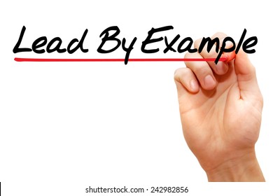 Hand writing Lead By Example with marker, business concept