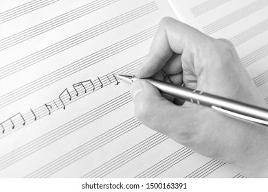 Hand Writing Music Notes Close-up In Black And White