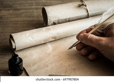 Hand writing with old quill pen on the old paper. Historical atmosphere. Empty place for a text.