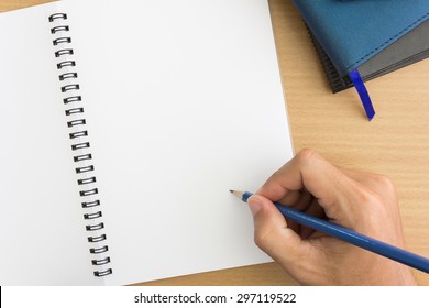 Hand Is Writing On  Blank Notebook
