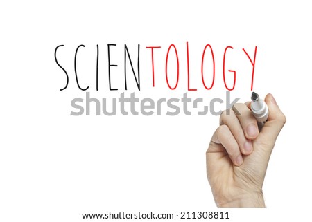 Hand writing scientology on a white board