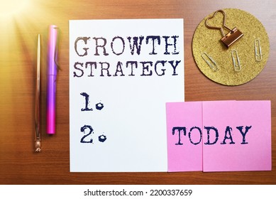 Hand writing sign Growth StrategyStrategy aimed at winning larger market share in short-term. Concept meaning Strategy aimed at winning larger market share in shortterm - Shutterstock ID 2200337659