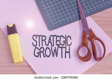 Hand Writing Sign Strategic Growth. Business Concept Create Plan Or Schedule To Increase Stocks Or Improvement Multiple Assorted Collection Office Stationery Photo Placed Over Table