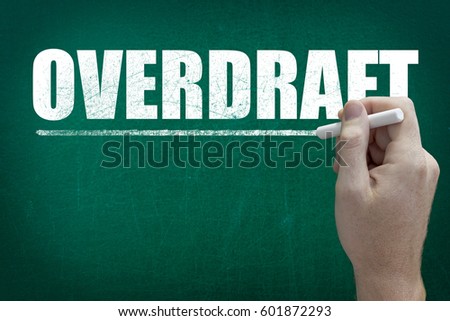 Hand writing the text Overdraft on the blackboard