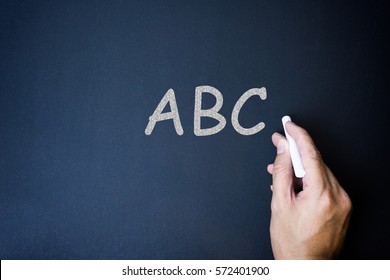 Hand Writing Text Say ABC On The Chalkboard.