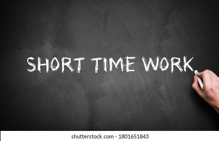 Hand Is Writing Text SHORT TIME WORK On A Chalkboard