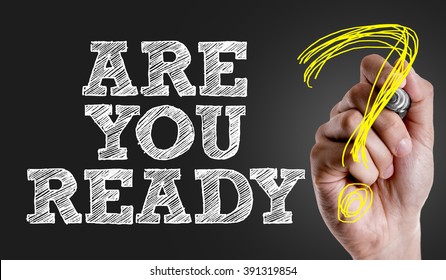 Hand writing the text: Are You Ready?