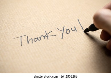 Hand writing thank you note on brown color paper