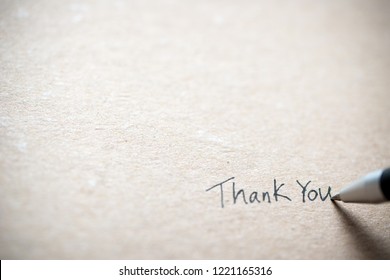 Hand writing thank you on piece of old grunge paper