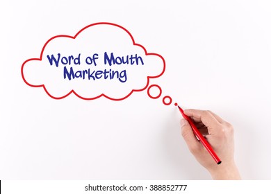 Hand Writing Word Of Mouth Marketing On White Paper, View From Above