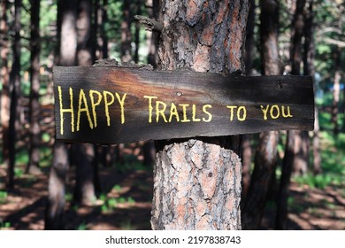 Hand Written Trail Sign Posted On A Tree. Happy Trails To You.