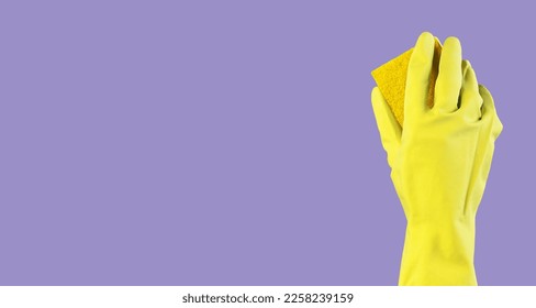 Hand in yellow glove cleaning, washing purple background, banner with sponge. Clean service ad with copy space. High quality photo - Shutterstock ID 2258239159
