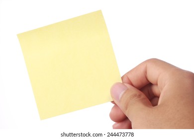 Hand with yellow sticky note isolated on white background.