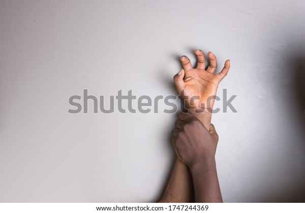 Hand of a young African girl being paped and the hand of\
the rapist. 