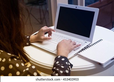 hand of young cute Asia woman is working with her notebook and mobile phone sitting on deluxe gold armchair - Shutterstock ID 453403903